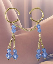 Gold pussy dangle jewellery with light blue Swarovski crystals