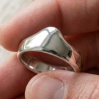 Customer holding silver glans bump cock ring