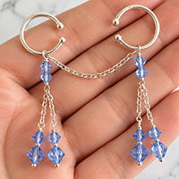 Customer holding a blue crystal and silver non-piercing pussy dangle