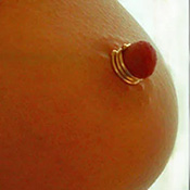 Smooth triple wrap silver nipple ring worn on the breast