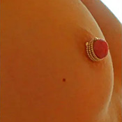 Twisted triple wrap silver nipple ring worn on the breast